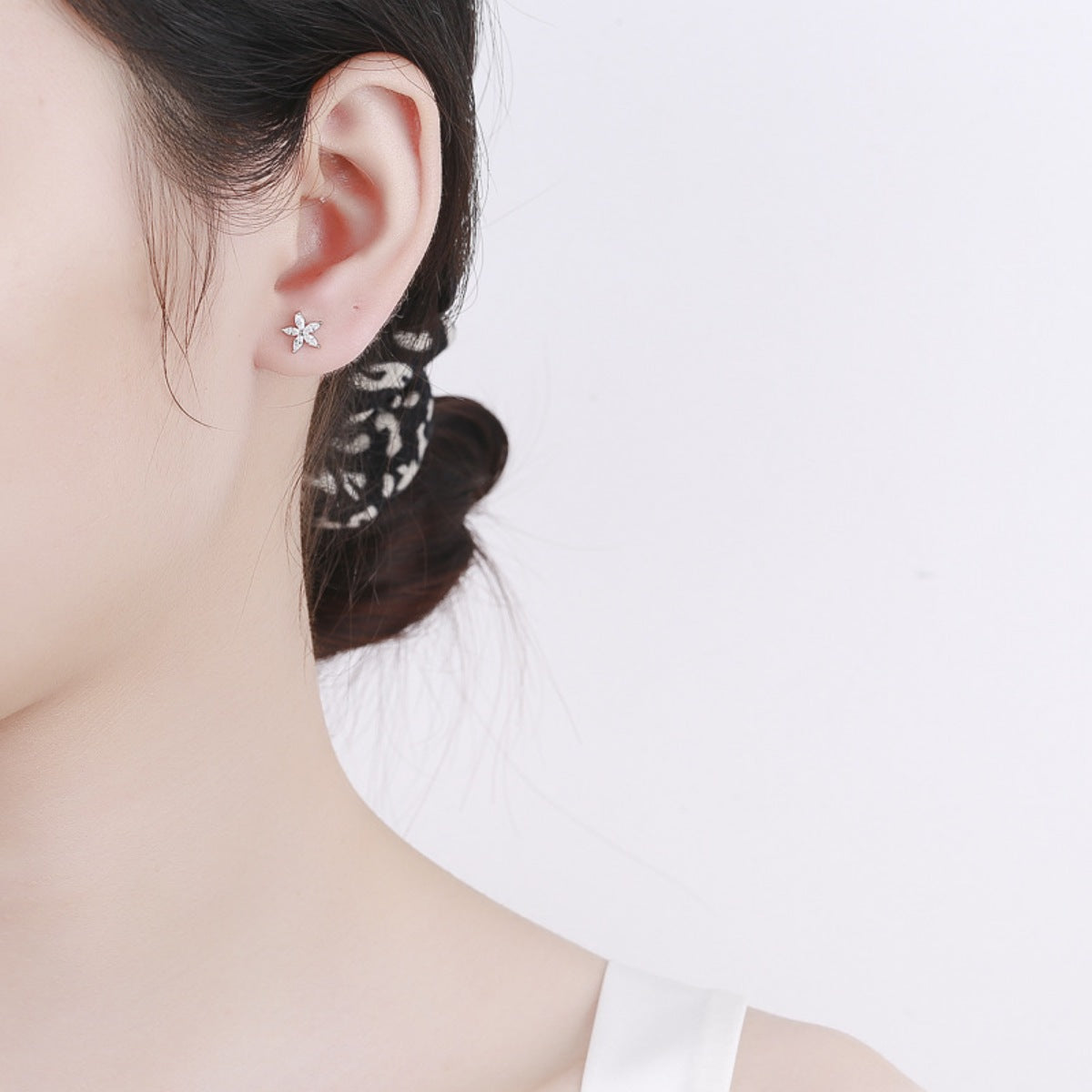 Elegant flower stud earrings in silver with delicate design.