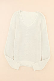Relaxed knit V-neck pullover sweater in beige with a subtle chevron stitch detail.
