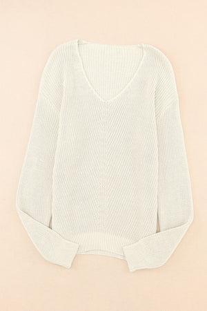 Relaxed knit V-neck pullover sweater in beige with a subtle chevron stitch detail.