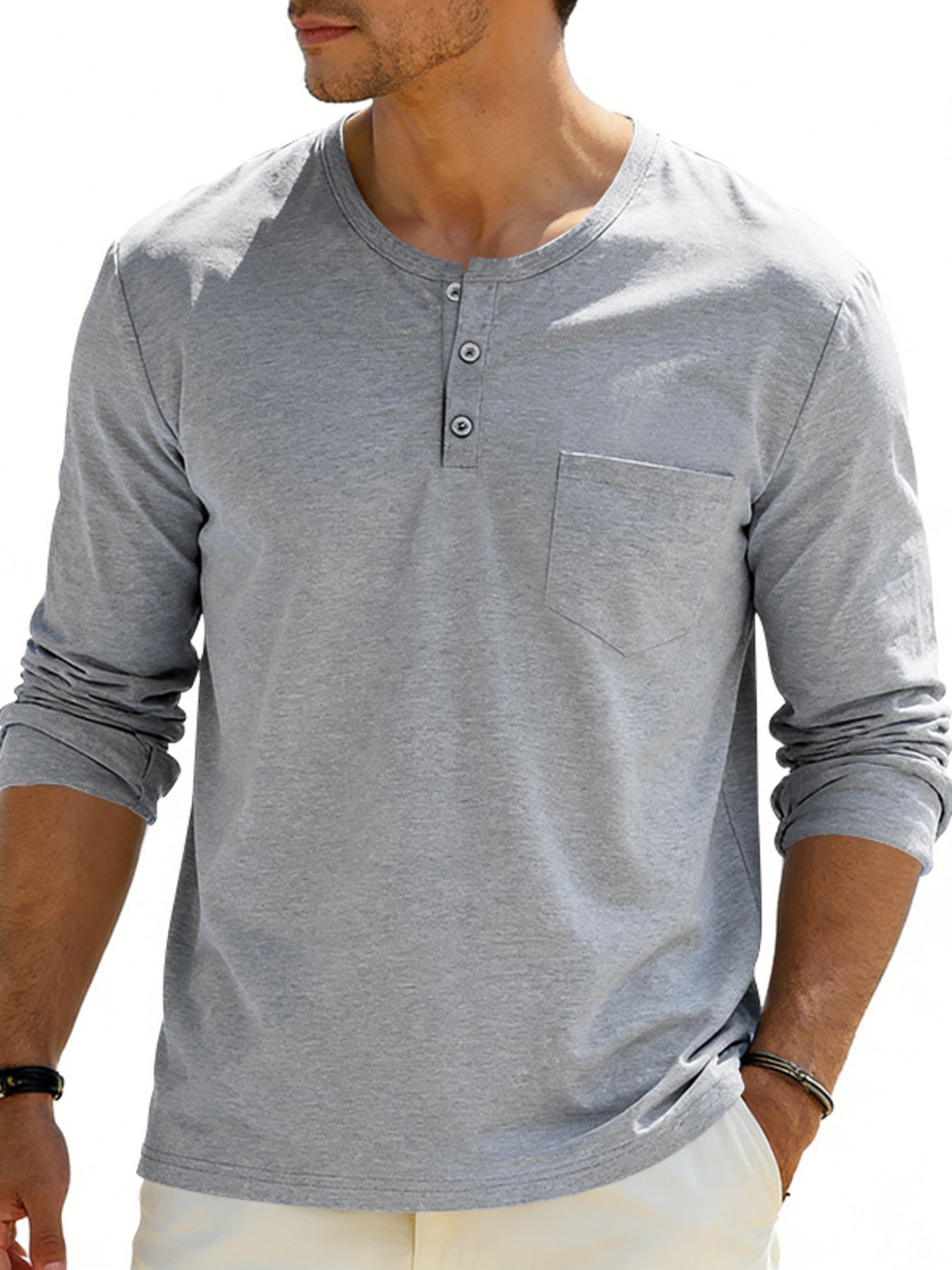 Gray long sleeve pocketed henley t-shirt with button placket and cuffed sleeves.