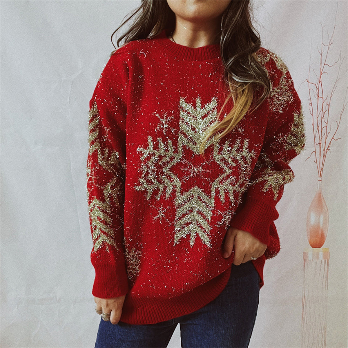 Red acrylic knit sweater with gold snowflake embellishments and metallic threads.