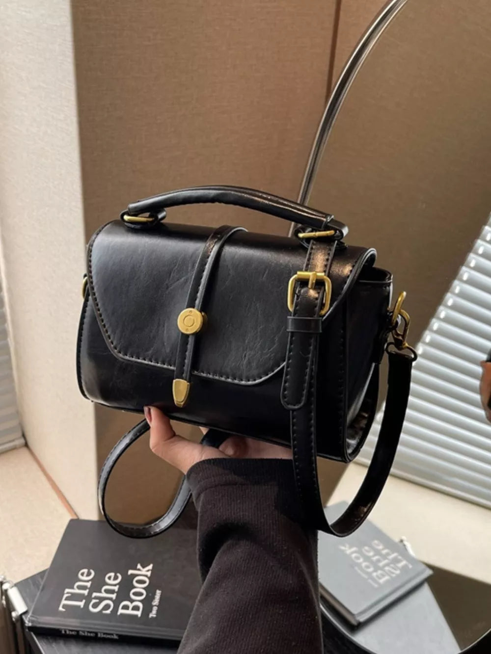 Black mini pu leather crossbody bag with gold clasp and adjustable strap