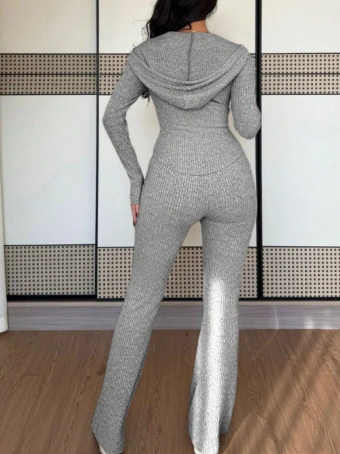 Light gray ribbed knit zip-up hooded set with flared pants.