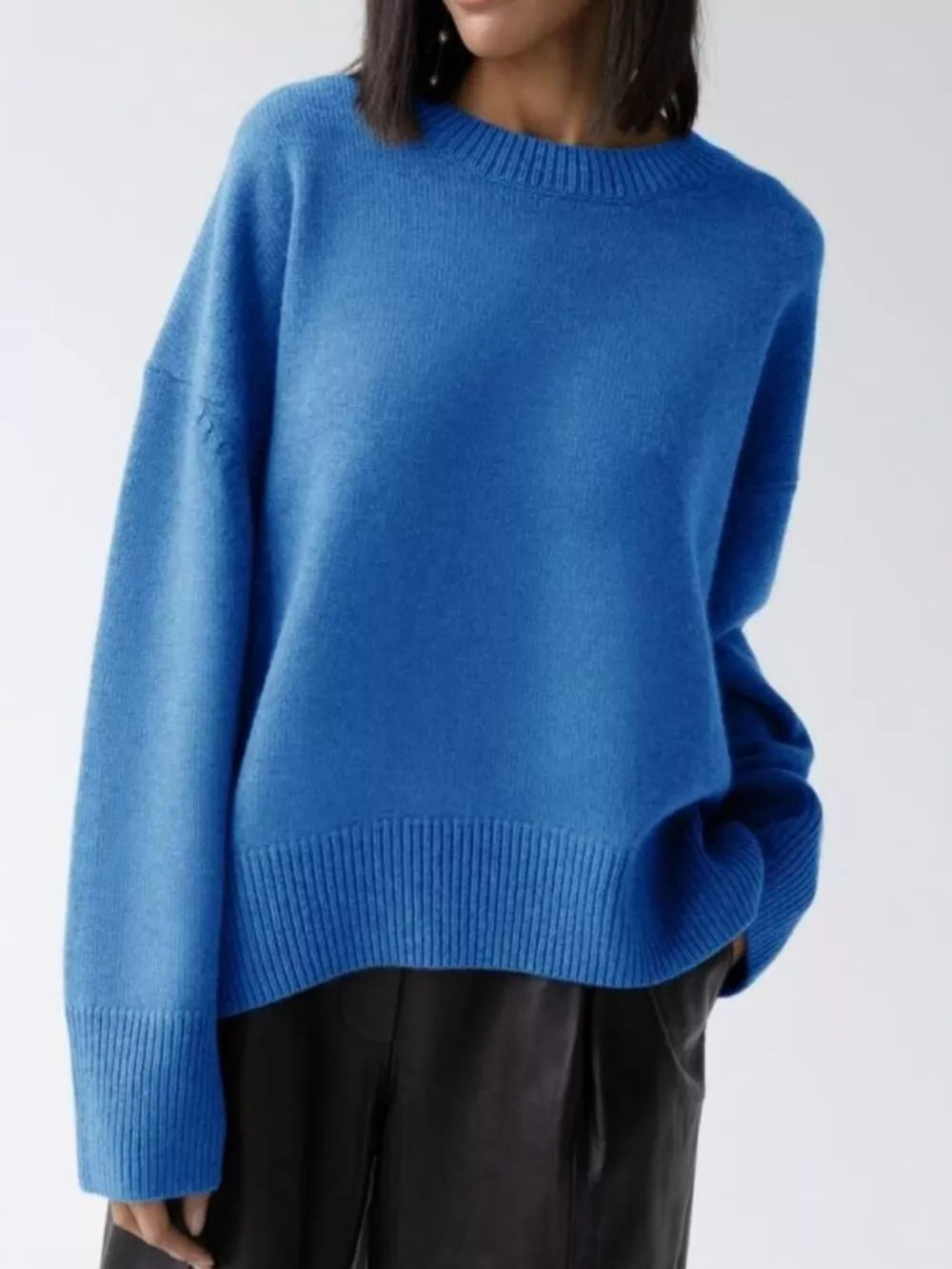 Soft knit sweater in light blue with ribbed detailing and crewneck.