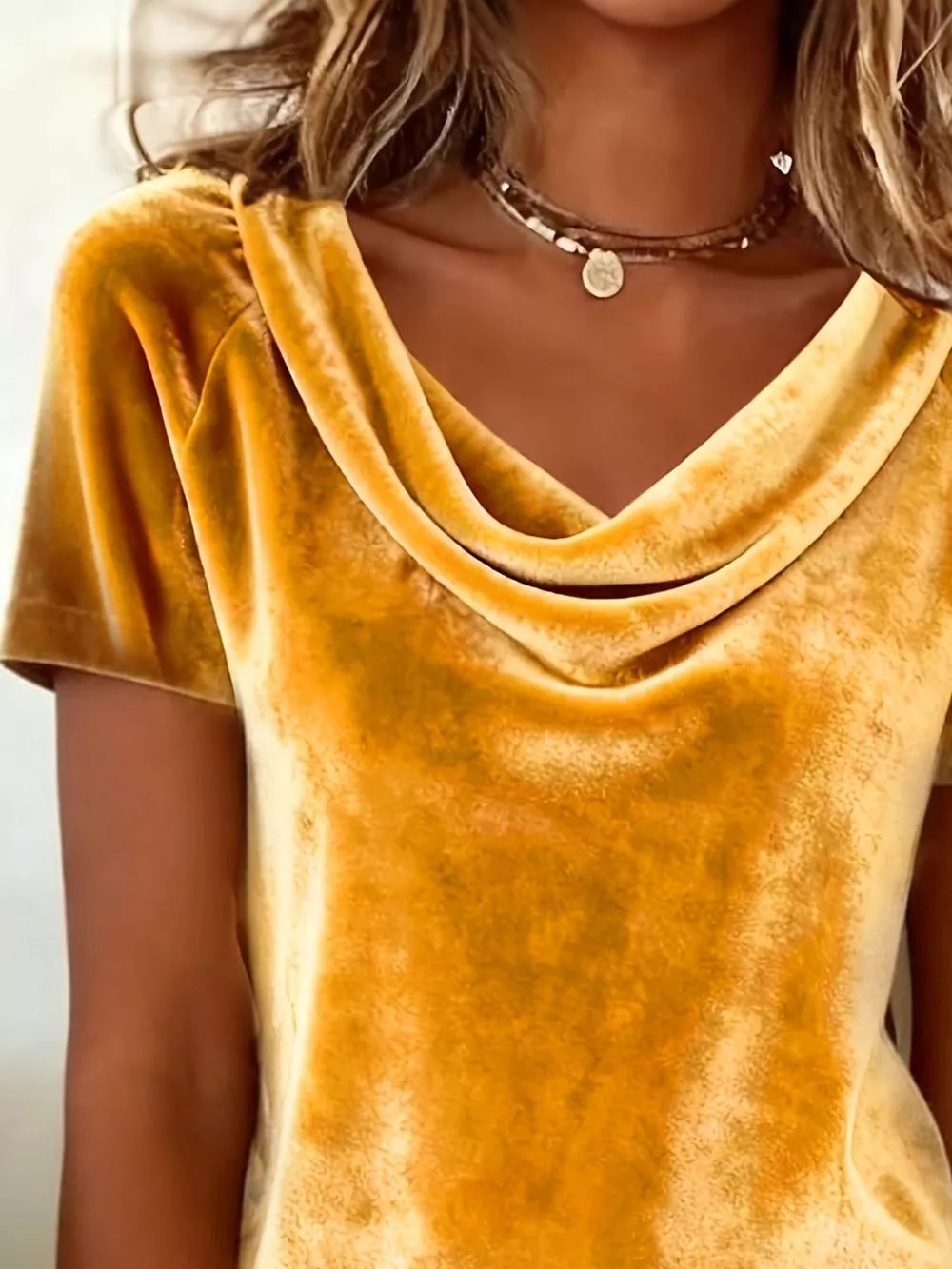 Gold velvet t-shirt with cowl neck and short sleeves.