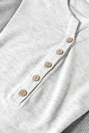 Gray waffle knit henley top with wooden buttons and a colorblock detail.