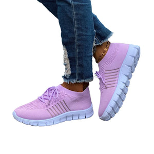 Lilac breathable knit runner sneakers with stripe detail and white soles.