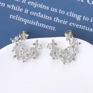 Silver floral cluster stud earrings with clear stones