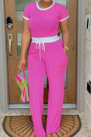 Hot Pink ribbed lounge set with contrast trim neckline and waistband, featuring wide leg pants and a drawstring.