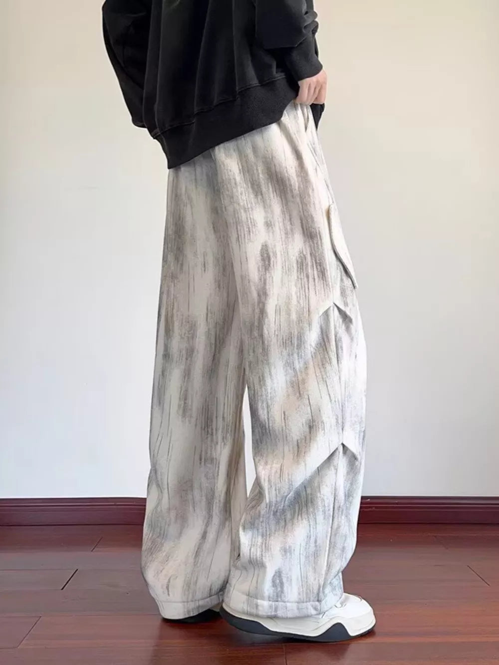 Off-white vintage wash utility cargo pants with a wide leg and drawstring waist.