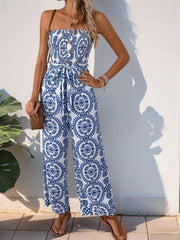 Blue print bustier wide leg jumpsuit with decorative buttons and tie waist.