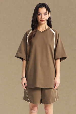Taupe V-neck raglan tee with white contrast trim on sleeves.
