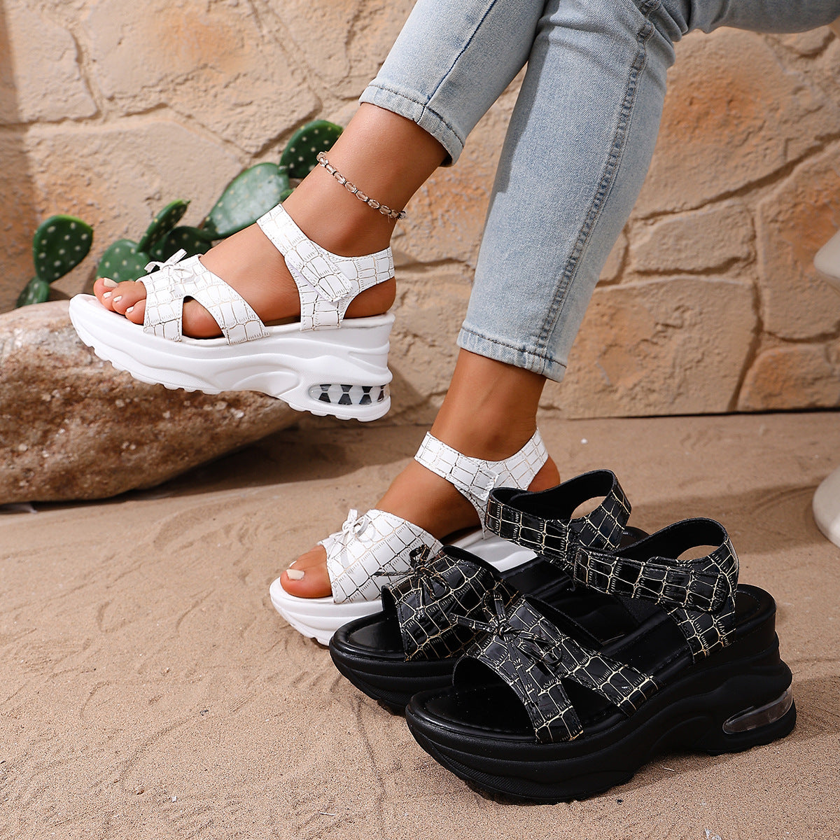 Textured open-toe wedge sandals in white and black with adjustable straps and air cushioning.