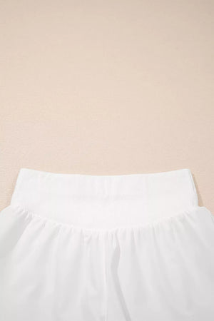 White ribbed-waist high rise relaxed shorts with a gathered fabric detail.