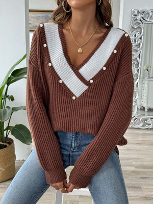 Caramel ribbed knit V-neck sweater with pearl trim and white stripe detail.
