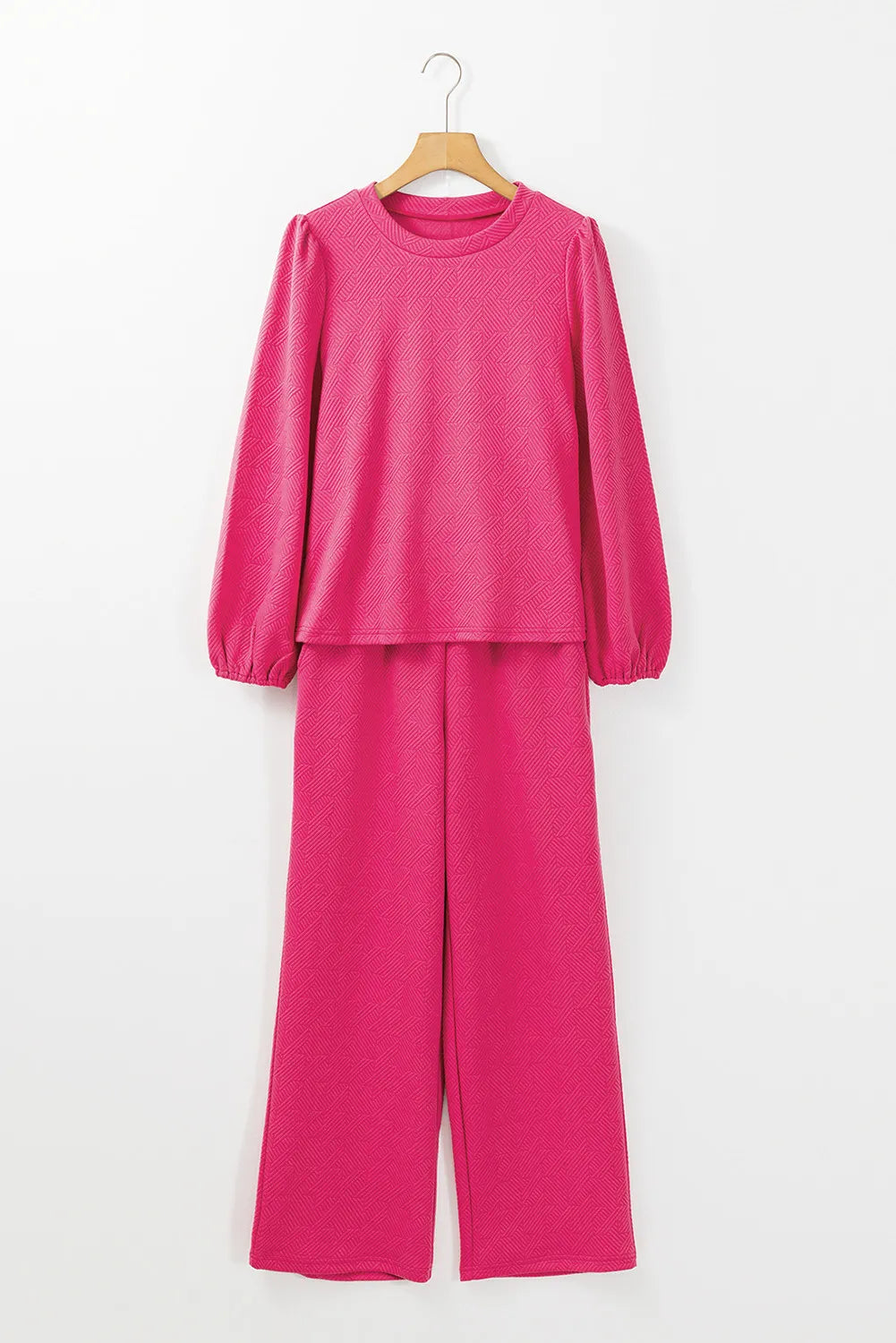 Textured puff sleeve lounge set in hot pink with a geometric pattern.