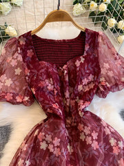 Crimson floral print maxi dress with sweetheart neckline and sheer puff sleeves.