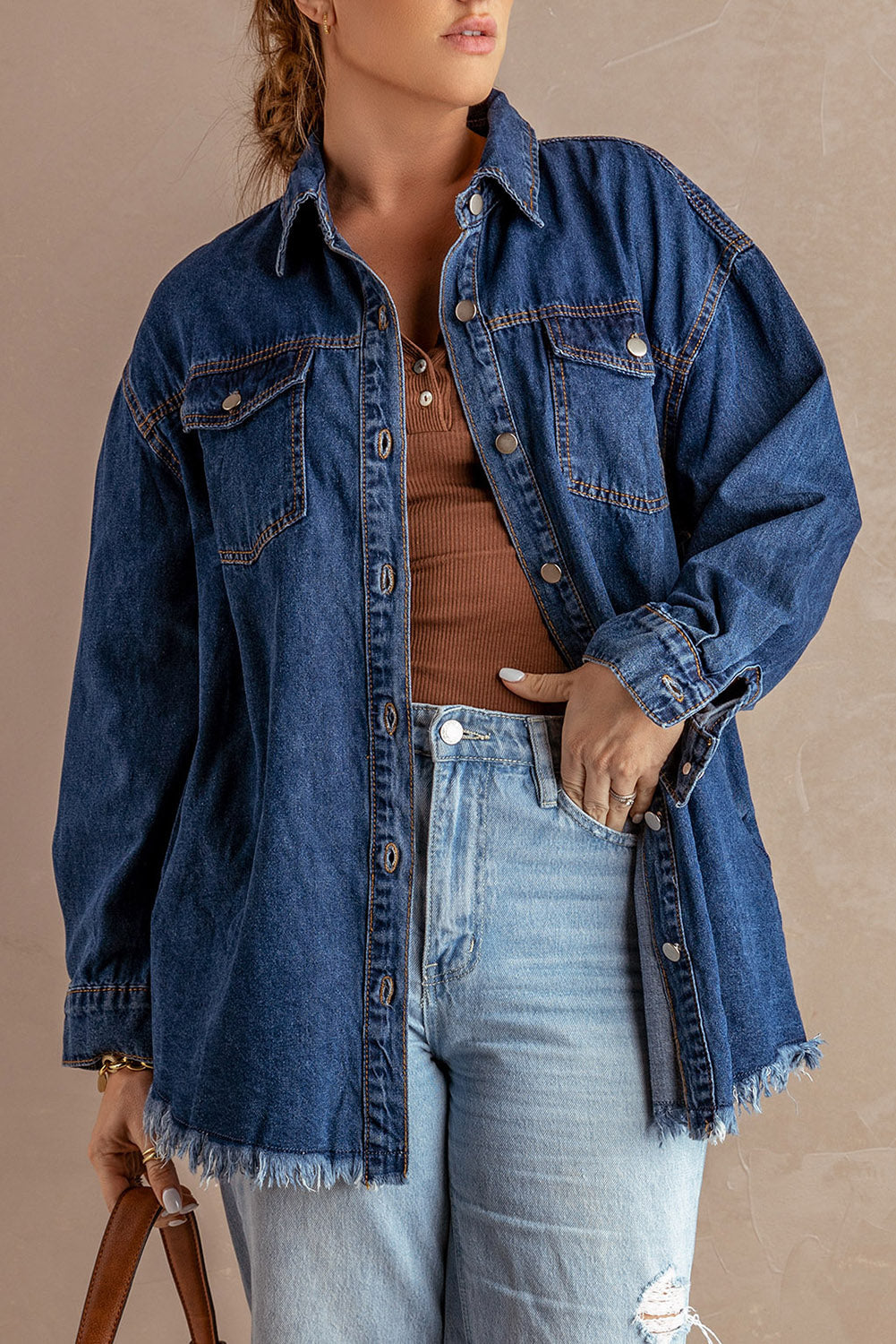 Dark blue denim oversized shirt jacket with frayed hem and button front