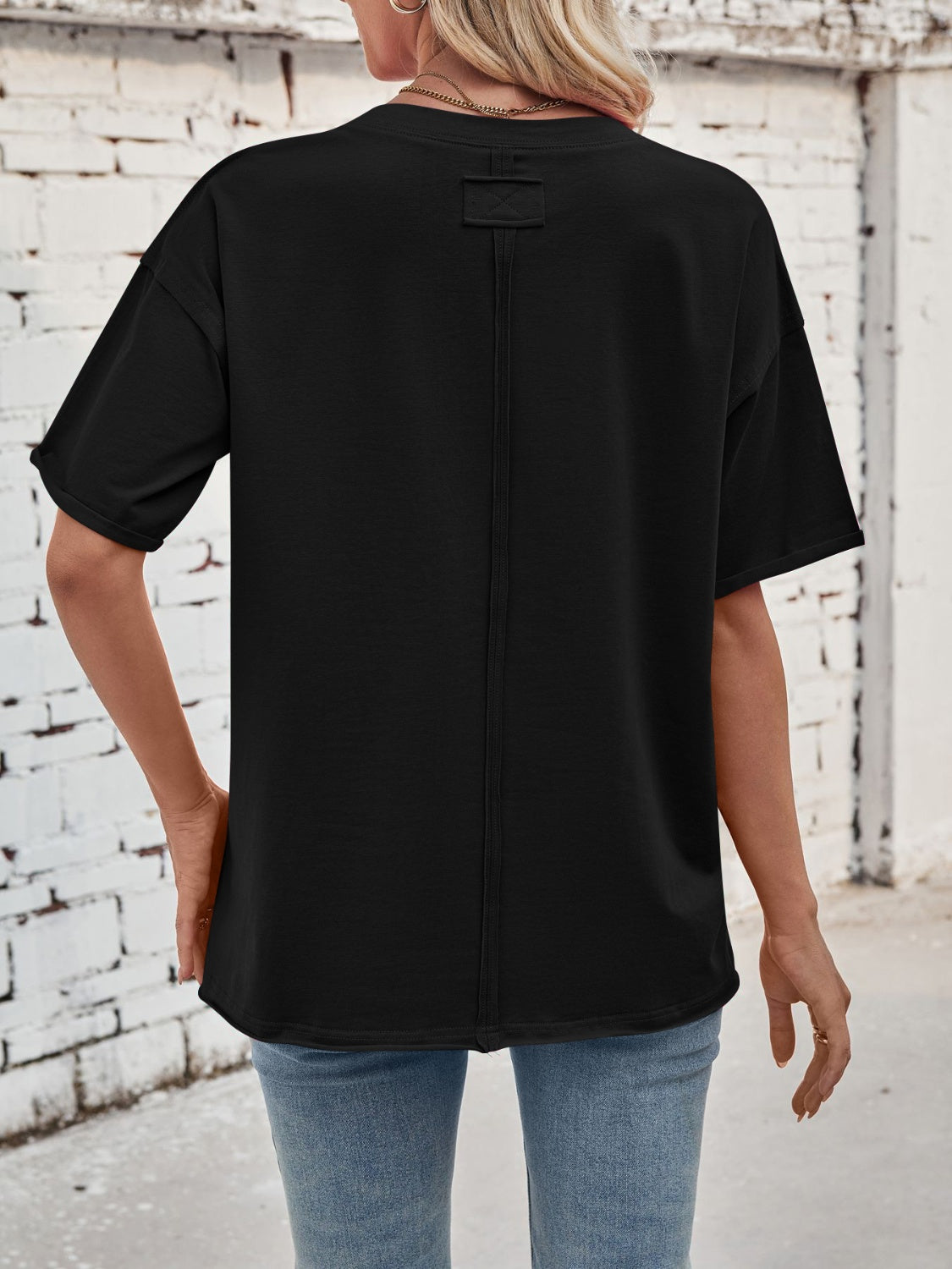 Black oversized cotton tee with seam detail and box tag detail on back.