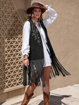 Black faux suede vest with turquoise embroidery and long fringe detail.