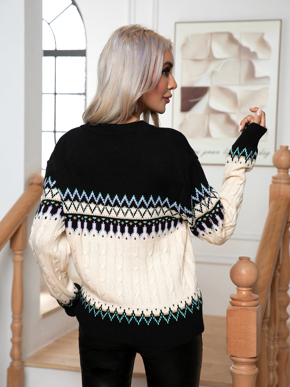 Black acrylic cable knit sweater with geometric Fair Isle pattern and cream lower half.