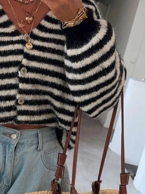 Charming cropped black and white striped knit cardigan with button front and balloon sleeves.