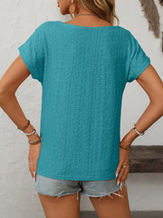 Teal eyelet knit tee with short sleeves and a boat neck, featuring a diamond pattern.