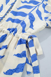 Maxi dress with botanical print, side tie, and button detail.