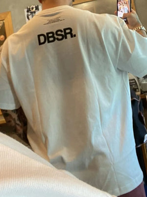 White oversized tee with bold black DBSR back print