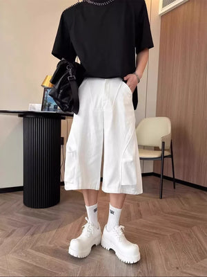 White relaxed fit cropped cargo pants with large side pockets and a pleated front.
