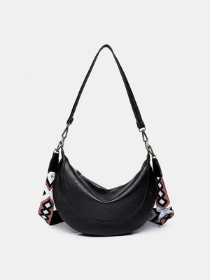 Black leather crescent crossbody bag with geometric strap