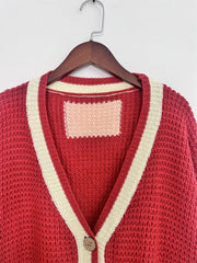 Scarlet textured knit cardigan with cream varsity stripes and a single button closure.