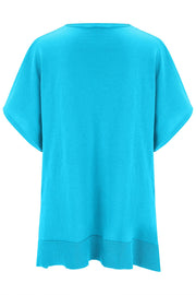 Cerulean knit poncho top with V-neck and short sleeves, ribbed hem detail.