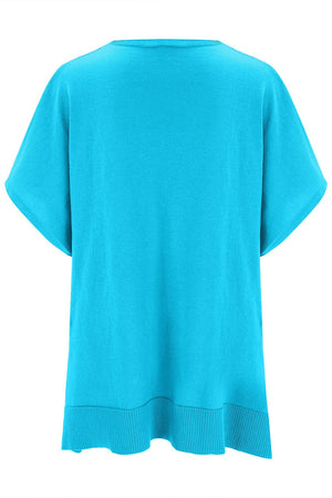 Cerulean knit poncho top with V-neck and short sleeves, ribbed hem detail.