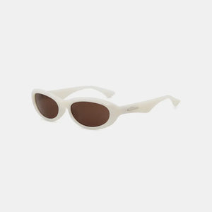 Ivory cat eye sunglasses with brown lenses and a chic, modern frame.