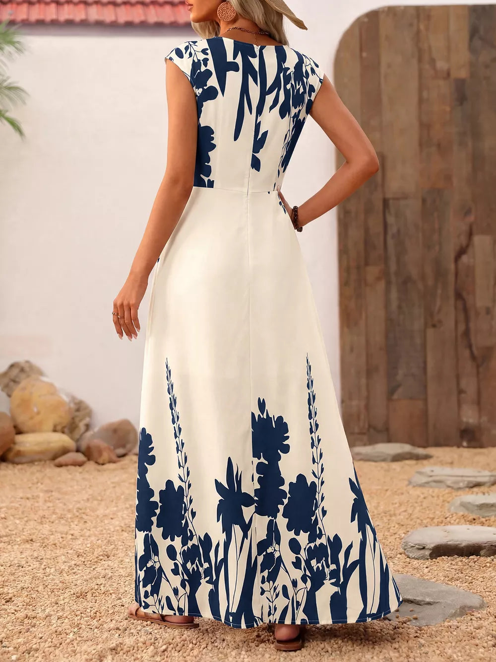 Botanical print maxi dress with cap sleeves and square neck in cream with navy blue floral pattern.