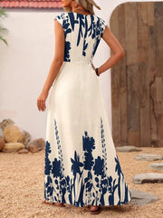 Botanical print maxi dress with cap sleeves and square neck in cream with navy blue floral pattern.