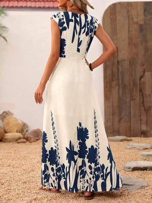 Botanical print maxi dress with cap sleeves and square neck in cream with navy blue floral pattern.