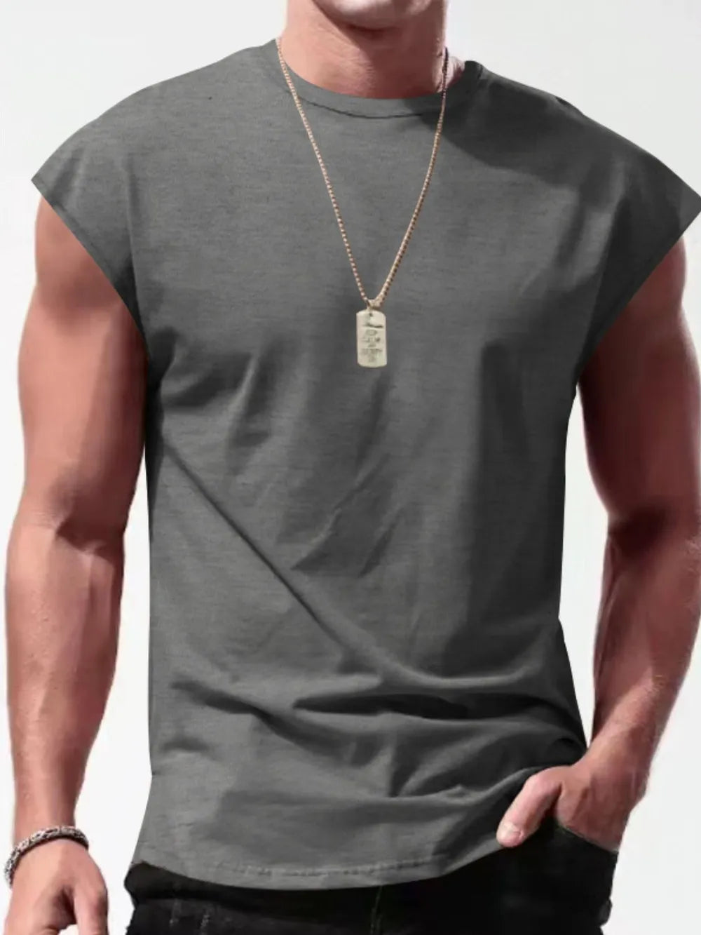 Muscle-fit sleeveless tee in dark gray with wide shoulders, crew neck, and a dog tag necklace.