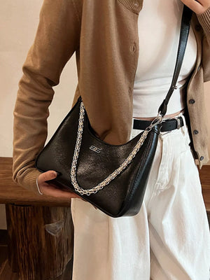 Black crossbody bag with chain detail and silver logo accent