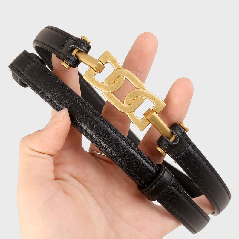 Black leather belt with brushed gold chain-link detail and gold buckle.