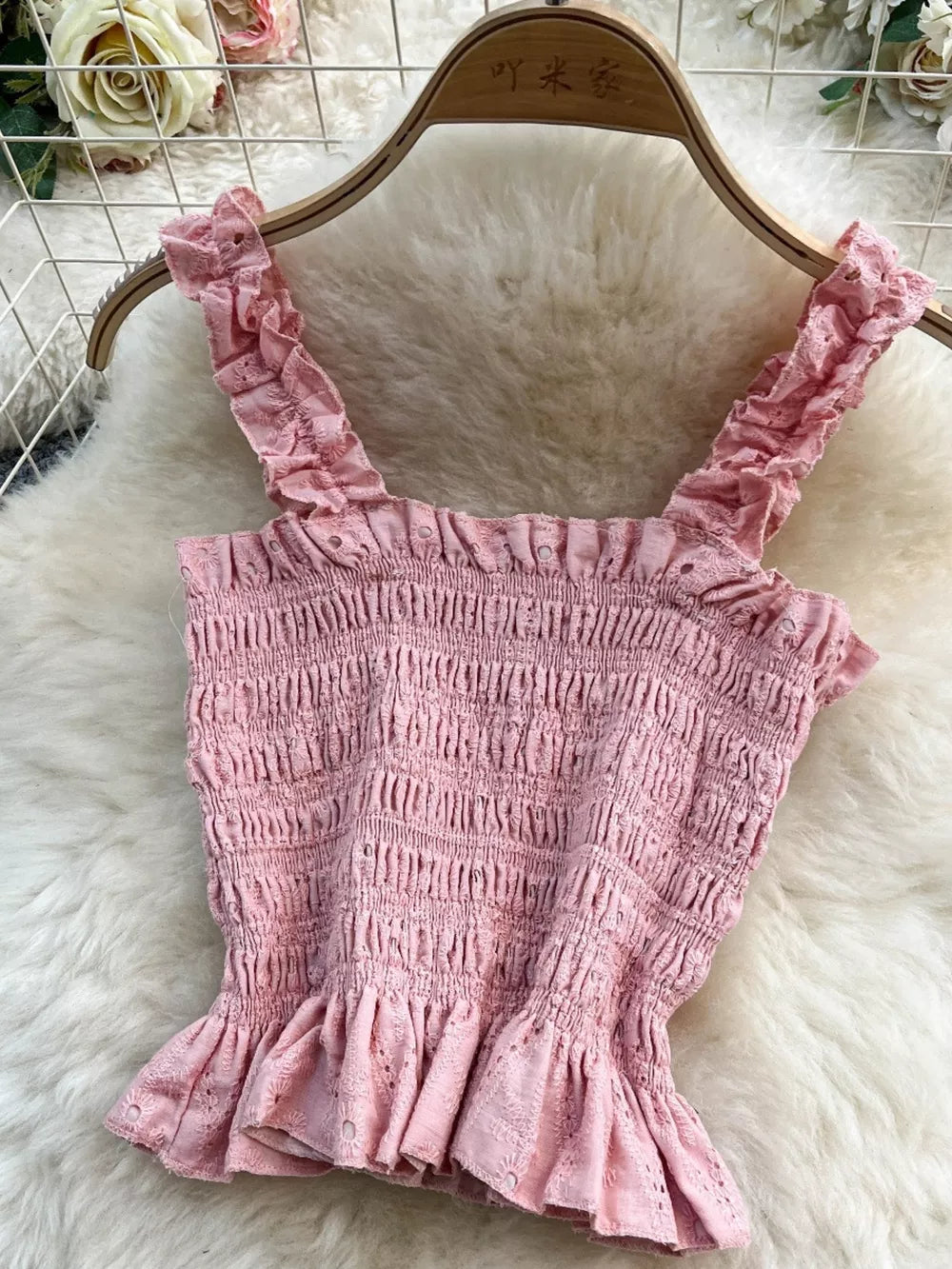 Pink eyelet crop top with ruffled straps and hem