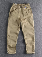 Khaki men's elastic waist cargo pants with button closure and cuffed hems.