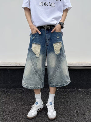 Men's distressed wide-leg denim shorts in blue with ripped details and a faded wash.