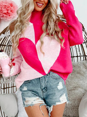 Hot pink acrylic sweater with open shoulders and a large heart motif.