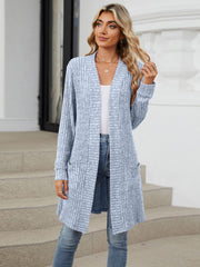 Dusty blue ribbed knit duster cardigan with pockets and open front, worn by a model.