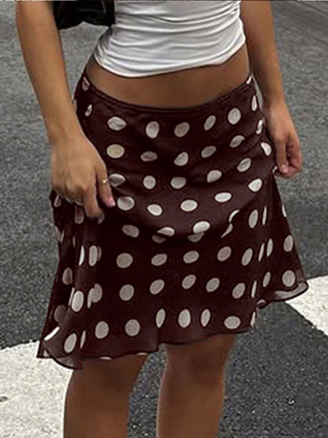 A-line mesh polka dot skirt in brown with a ruffled hem.