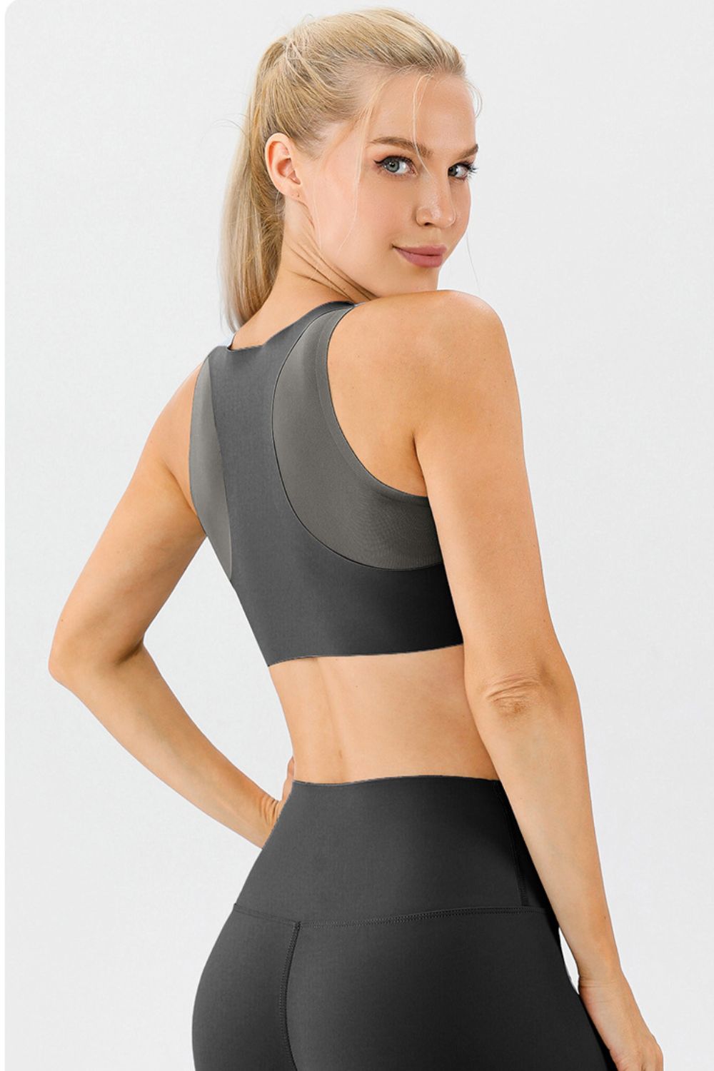 Sculpted Performance Sports Bra in charcoal grey with contrasting panels and a racerback design.