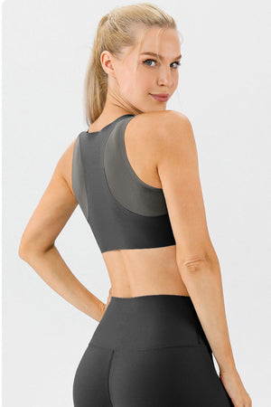 Sculpted Performance Sports Bra in charcoal grey with contrasting panels and a racerback design.