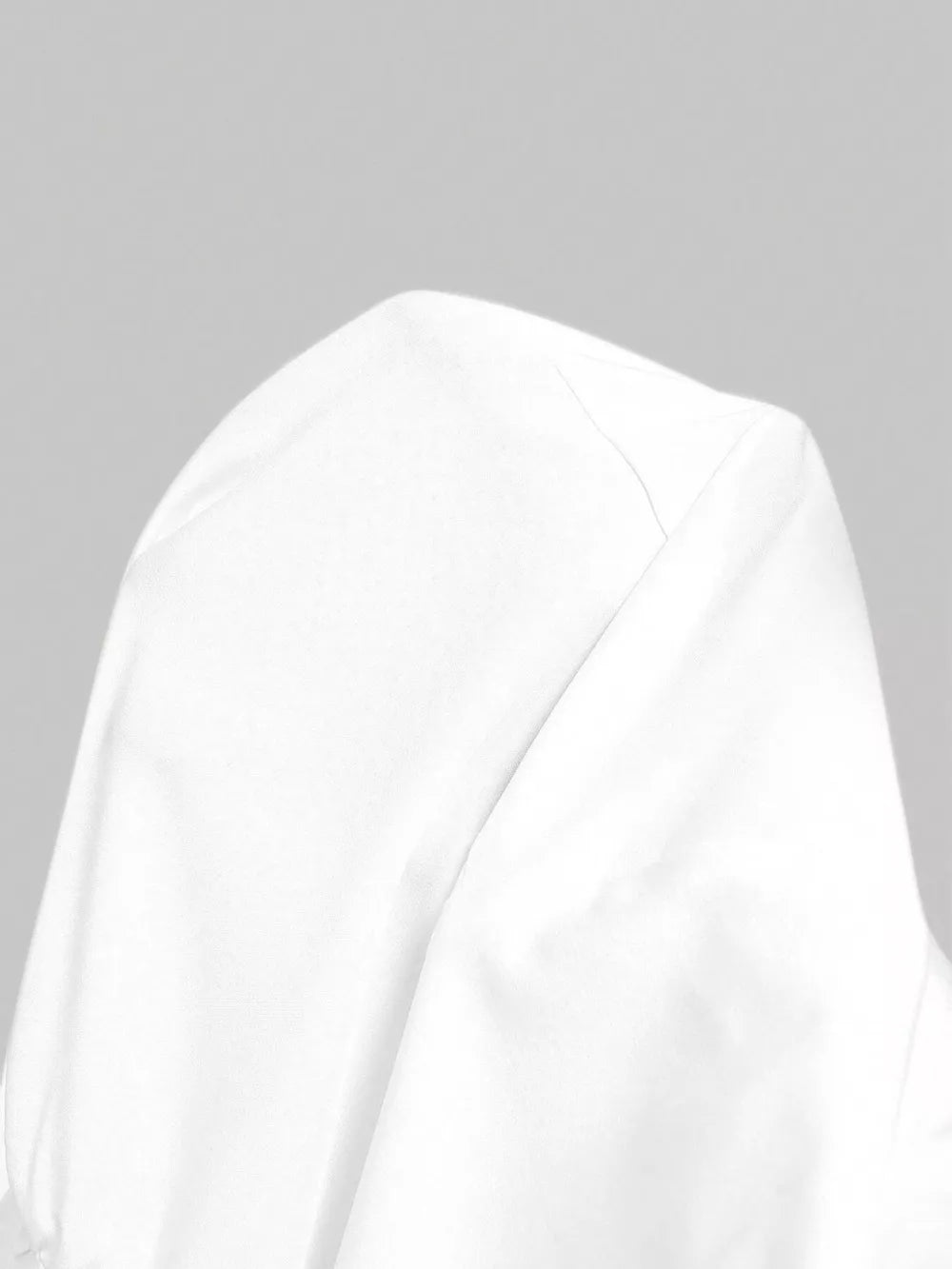 White asymmetrical collared long-sleeve shirt showing shoulder detail
